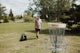 a person stands next to a bird feeder