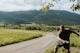 a man holding a frisbee on a dirt road