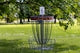 a frisbee golf cage in the middle of a park