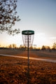 a frisbee golf hole in the middle of a field