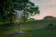 a blue and white frisbee golf goal in a field