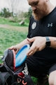 Man placing a disc golf disc into a bag
