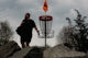 Man walking with disc golf basket and flag