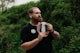 Man holding a disc golf disc outdoors